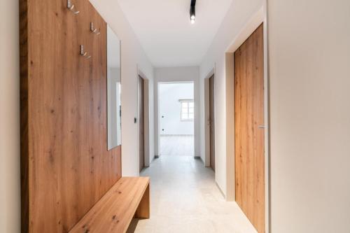 a hallway with wood paneling and a wooden bench at Stadthaus Rosengartenschlucht in Imst