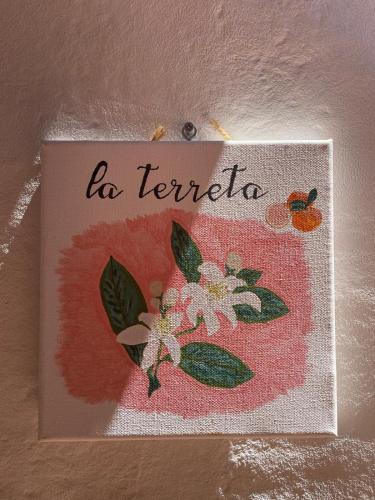 a painting of flowers with the words be terrier at La Terreta hotel casa rural in El Brosquil