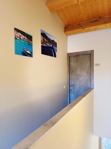 a hallway with a door and three pictures on the wall at Citrus Holidays House in Catania
