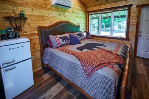 a bedroom with a bed in a log cabin at Creekwalk Inn Bed and Breakfast with Cabins in Cosby