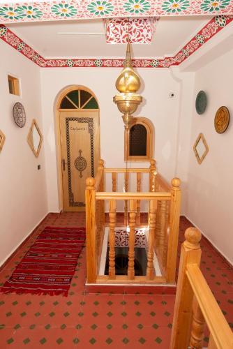 a room with a staircase and a door with a rug at Riad KASBAH in Tangier