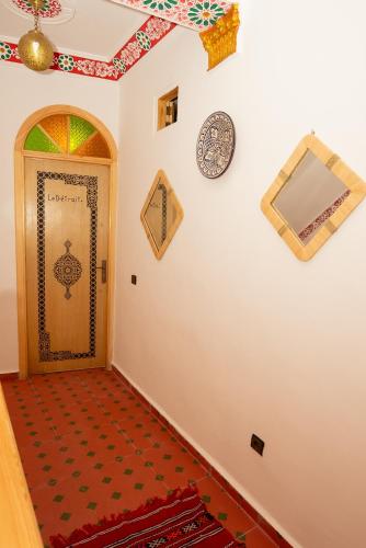 a hallway with a door with a painting on the wall at Riad KASBAH in Tangier