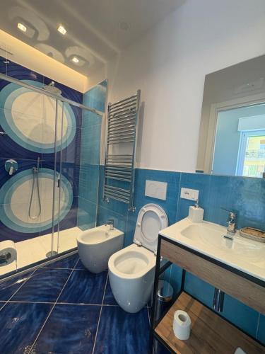 a bathroom with a toilet and a sink and a shower at De Riso Rooms in Maiori