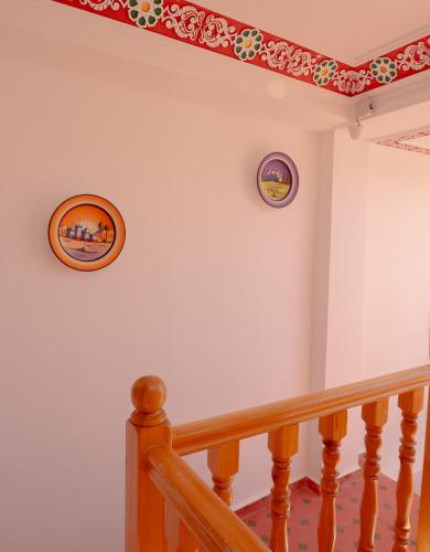 a stairway with two pictures on the wall and a stair railing at Riad KASBAH in Tangier