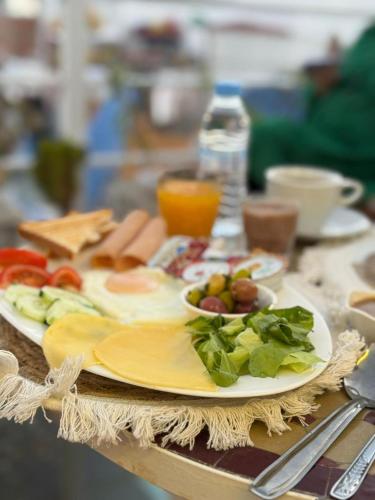 a plate of food on a table with a plate of food at Riad KASBAH in Tangier