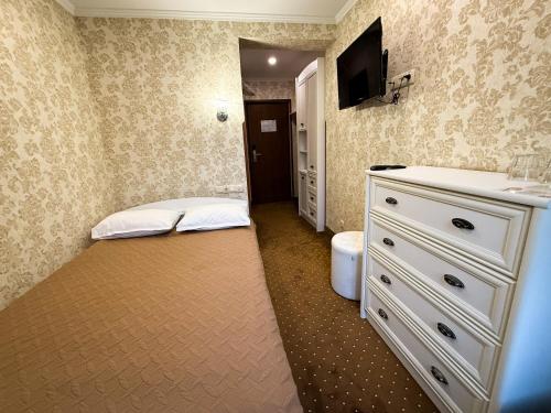 a bathroom with two beds and a sink and a mirror at VitaPark Stariy Dub in Truskavets