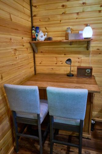 a room with a wooden table and two chairs at Creekwalk Inn Bed and Breakfast with Cabins in Cosby