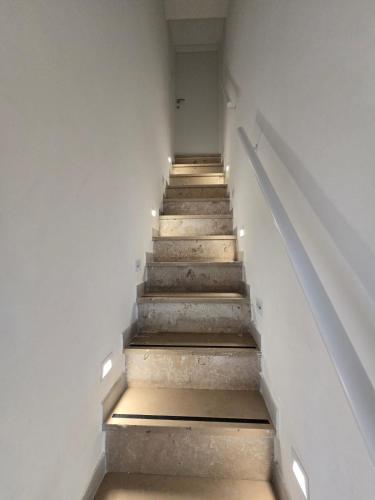 a stairway with steps in a building with lights at Mare e Relax in Mola di Bari