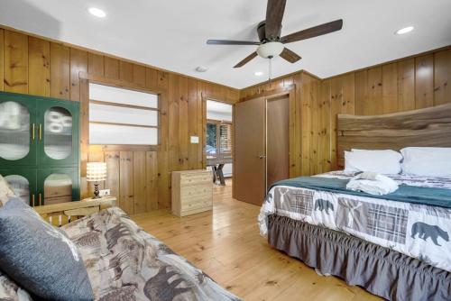 a bedroom with a bed and a ceiling fan at 2 Homes Retreat Game Rooms & Fire Pit Winni in Moultonborough