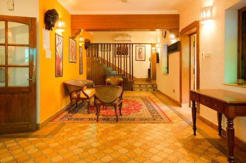a hallway with chairs and a table in a house at Casa Memora 3BHK Private Pool Villa in Saligao