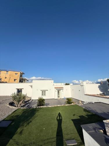 a shadow of a person standing on a lawn at Carotenuto Palace in Boscotrecase