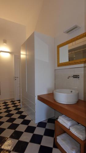 a bathroom with a sink and a mirror at Ganimede Centro Storico in Sperlonga