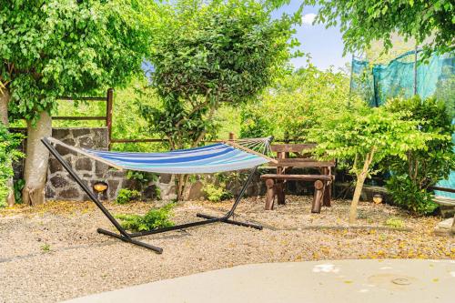 a hammock in the middle of a garden at Le Latanier - Perfect Mauritius Stay in La Gaulette