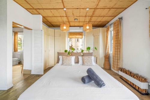a bedroom with a large white bed in a room at Le Latanier - Perfect Mauritius Stay in La Gaulette