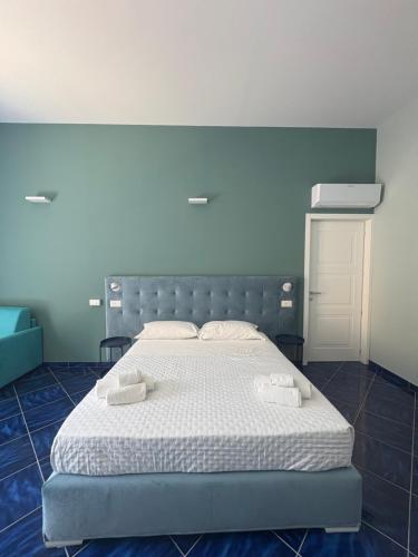a bedroom with a bed with two towels on it at De Riso Rooms in Maiori