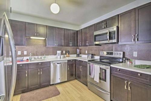 a kitchen with wooden cabinets and stainless steel appliances at Harbor furnished apartments free indoor parking in Baltimore