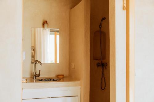 a bathroom with a sink and a mirror at The Ocean Surf Villa in Dakhla