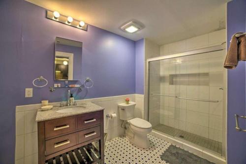 a purple bathroom with a toilet and a shower at Harbor furnished apartments free indoor parking in Baltimore