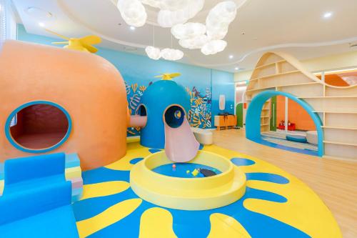 a childrens room with a play area with a slide at Capella Apartment Fireworks and Ocean View- Hillside Phu Quoc in Phu Quoc