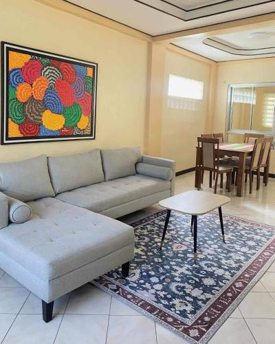 a living room with a couch and a table at Cozy 3br home entry to CWC, Pili Golf, Naga, Bicol in Pili