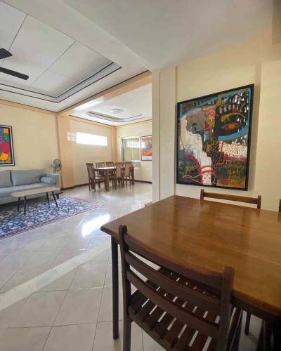 a living room with a table and a couch at Cozy 3br home entry to CWC, Pili Golf, Naga, Bicol in Pili