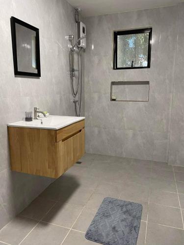 a bathroom with a sink and a shower at Cozy 3br home entry to CWC, Pili Golf, Naga, Bicol in Pili