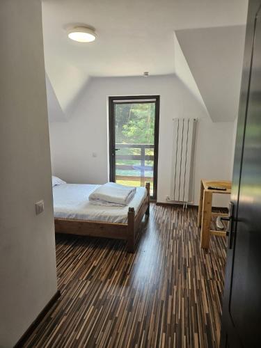 a small bedroom with a bed and a window at Vaya Retreat in Săsenii Vechi