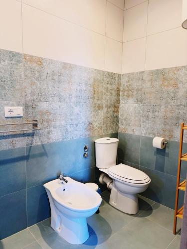a bathroom with a toilet and a sink at Citrus Holidays House in Catania