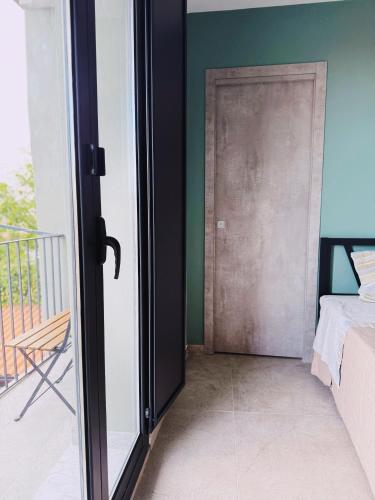 a door leading to a balcony with a bed at Citrus Holidays House in Catania