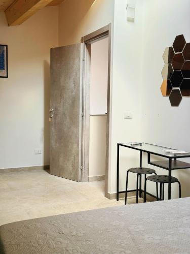 a room with a table and two chairs and a door at Citrus Holidays House in Catania