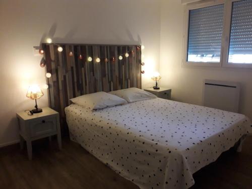 a bedroom with a bed with two tables and two lamps at Villa Pillapi in Céret