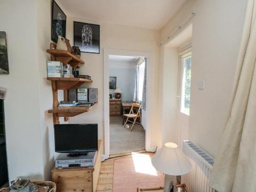 a living room with a television and a hallway at Low Muffles Bridge in Pickering