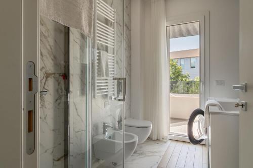 a white bathroom with a toilet and a sink at Palladio13 in San Benedetto del Tronto