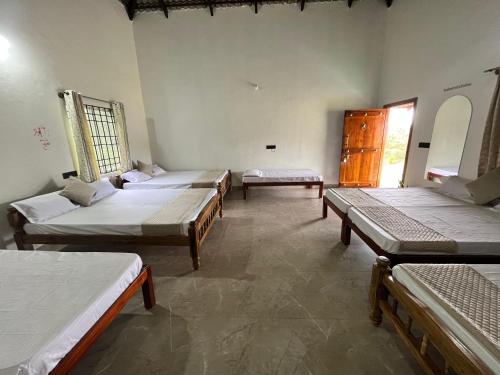 a room with four beds in a room at Kavalubare Retreat by Dazzle Destinations - Private Cottages and Near to City in Chikmagalūr