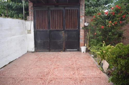 an entrance to a building with a large black door at Las calas in San Clemente del Tuyú