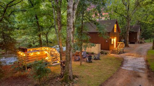 a cabin in the woods next to a road at Creekwalk Inn Bed and Breakfast with Cabins in Cosby