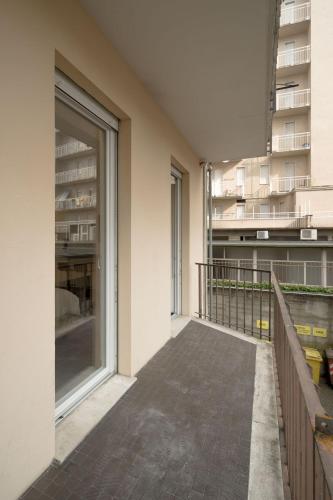 an empty balcony of a building with large windows at Room 52 - stanza da sogno in Biella