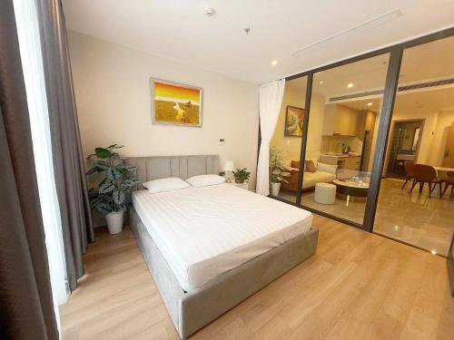 a bedroom with a large bed and a living room at ICON40 Ha Long Luxury Apart in Ha Long