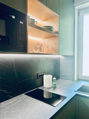a kitchen with a counter top with a candle on it at Bussiness Loft Oldcity in Iaşi