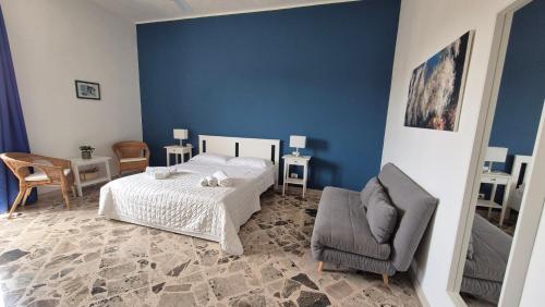 a blue bedroom with a bed and a chair at Angolo del Mare - Case Libeccio e Blu Marino in Favignana