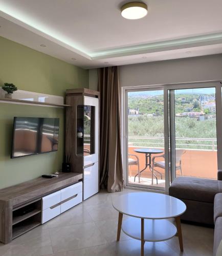 a living room with a couch and a table at Apartments Aura in Utjeha
