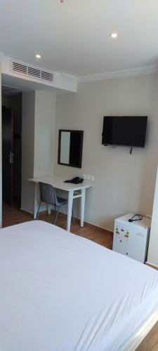 a bedroom with a bed and a desk with a computer at Hotel BLADOR in Tichi