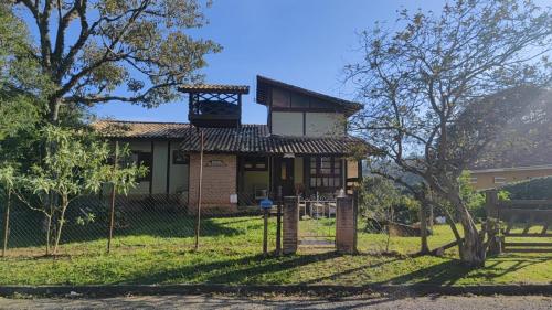 a house with a tower on top of it at Pe na Pedra quarto 3 in Atibaia