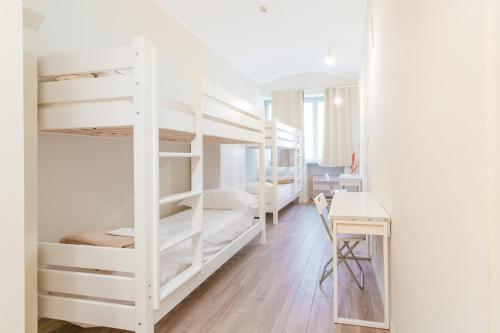 Ένα ή περισσότερα κρεβάτια σε δωμάτιο στο Tomato Backpackers