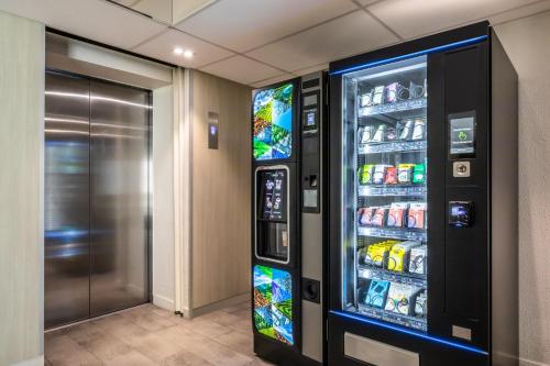a vending machine with drinks in a room at ibis Paris Porte de Montreuil in Paris