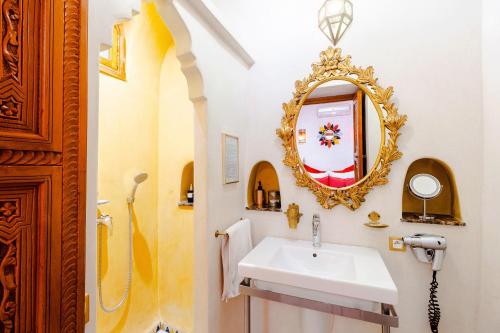 a bathroom with a sink and a mirror at Riad Asrari in Marrakech
