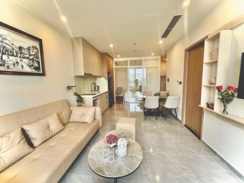 a living room with a couch and a table at ICON40 Ha Long Luxury Apart in Ha Long