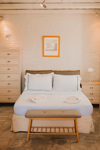 a bed with a wooden frame in a bedroom at Dinora Villa in Agios Ioannis Tinos