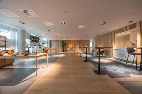 a lobby of a building with tables and chairs at Crowne Plaza Utrecht - Central Station by IHG in Utrecht