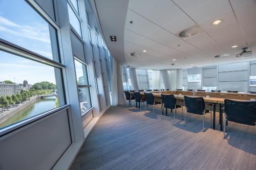 a conference room with a long table and chairs at Crowne Plaza Utrecht - Central Station by IHG in Utrecht